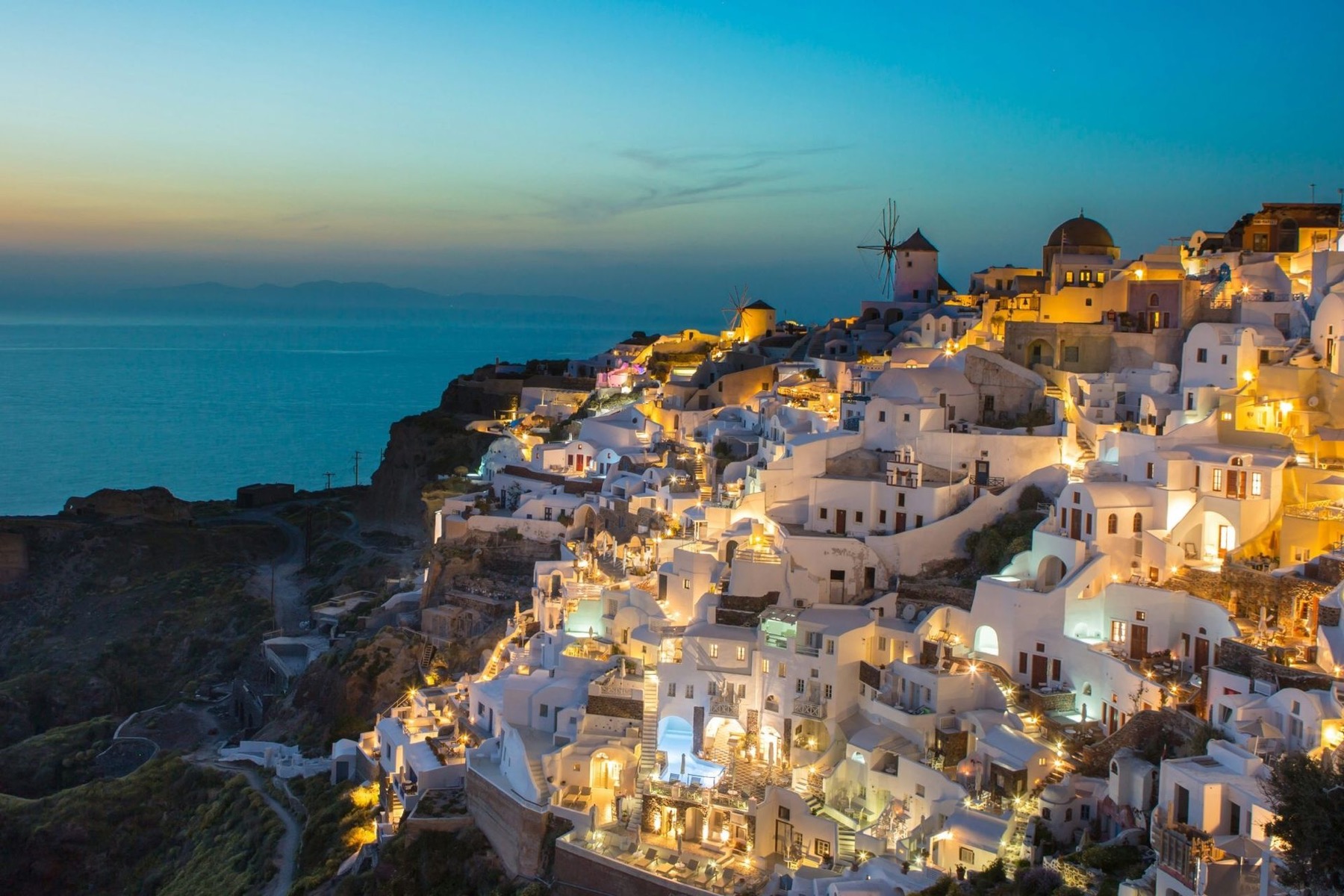 Oia, Santorini at dusk, the destination register for the Luxury Dental Retreats sub-brand.